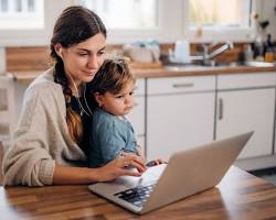 Hình ảnh về Mother studying nursing online with child nearby