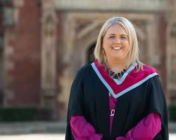 Hình ảnh về Nurse in graduation gown, smiling confidently